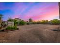 Expansive backyard featuring a shed, gardening area, and ample space for outdoor activities at 9283 W Denton Ln, Glendale, AZ 85305