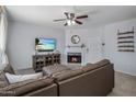 Bright living room with a corner fireplace, tile flooring, and a modern ceiling fan at 9451 E Becker Ln # 1041, Scottsdale, AZ 85260