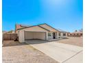 A single-story home features a covered carport, solar panels, and a low-maintenance yard at 9903 N 87Th Dr, Peoria, AZ 85345