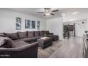 Inviting living room features neutral tones, modern ceiling fan, and an open floor plan at 9903 N 87Th Dr, Peoria, AZ 85345