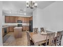 Well-appointed kitchen featuring wood cabinetry, granite countertops, and an island for extra prep space at 10132 E Isleta Ave, Mesa, AZ 85209