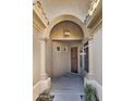 Inviting arched entryway features a wood door, side window, and hanging lantern at 10160 E Conieson Rd, Scottsdale, AZ 85260