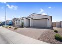 A charming single-story home featuring desert landscaping and brick-paved driveway at 11341 E Unger Ave, Mesa, AZ 85212