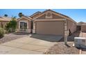 Single-story home with a spacious driveway and manicured desert landscaping at 1137 W 21St Ave, Apache Junction, AZ 85120