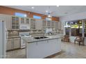 Well-lit kitchen with granite countertops, a tile backsplash, and stainless steel appliances at 11413 S Coolwater Dr, Goodyear, AZ 85338