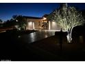 Charming single-story home with desert landscaping, a long driveway, a two-car garage, and landscape lighting at 12950 W Quinto Dr, Sun City West, AZ 85375