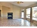 Spacious living room featuring tile floors, a modern fireplace, and plenty of natural light at 1490 W Laurel Ave, Gilbert, AZ 85233