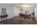 Bright dining room boasts a wooden table with elegant seating and stylish decor at 1642 E Cardinal Dr, Casa Grande, AZ 85122