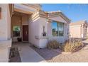 Inviting front entrance with a decorative door and manicured landscaping at 1642 E Cardinal Dr, Casa Grande, AZ 85122