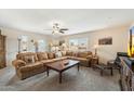 Spacious living room with large sectional sofa, ceiling fan, and ample natural light at 17010 E Calle Del Oro -- # D, Fountain Hills, AZ 85268