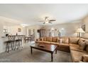Inviting living room featuring a large sofa, adjacent dining area, and easy access to the kitchen at 17010 E Calle Del Oro -- # D, Fountain Hills, AZ 85268
