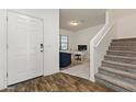 Bright entryway with staircase, stylish floors, and a doorway to what looks like an office at 17043 N Avelino Dr, Maricopa, AZ 85138