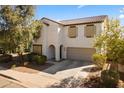 Daytime shot of this two-story home featuring a desert-style landscape and a two car garage at 17043 N Avelino Dr, Maricopa, AZ 85138
