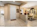 Neutral toned entryway that flows into the dining room area with easy access to other rooms at 19722 N Regents Park Dr, Surprise, AZ 85387
