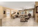 Spacious living room with neutral colored walls, tile floors, and plenty of room for entertaining at 19722 N Regents Park Dr, Surprise, AZ 85387