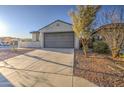 Attractive home with a two-car garage, desert landscaping, and a well-kept lawn at 20162 W Buchanan St, Buckeye, AZ 85326