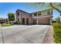 Spacious two-story home with a stone facade, a three-car garage, and a large driveway at 26722 N 90Th Ln, Peoria, AZ 85383