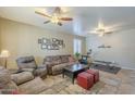 Large open living room with couches, ceiling fans, and plenty of space at 26842 N 176Th Ln, Surprise, AZ 85387