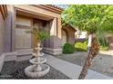 Charming front entrance featuring a tiered fountain, desert landscaping, and a welcoming walkway at 2894 E Melody Ln, Gilbert, AZ 85234