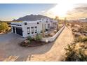 Stunning desert home boasts mountain views, a crisp white facade, and low-maintenance desert landscaping at 37646 N Dream St, Carefree, AZ 85377