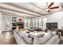 Spacious living room with high ceilings, exposed beams, fireplace, and large windows at 37646 N Dream St, Carefree, AZ 85377
