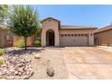 Single-story home featuring a neutral color palette and a well-maintained front yard at 38167 W Santa Clara Ave, Maricopa, AZ 85138