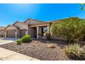 Charming single-story home showcasing a well-maintained front yard and an attached two-car garage at 41961 W Centennial Rd, Maricopa, AZ 85138