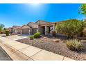 Charming single-story home showcasing a well-maintained front yard and an attached two-car garage at 41961 W Centennial Rd, Maricopa, AZ 85138