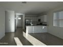 Open-concept living space showcases tile floors, recessed lighting, and a stylish kitchen with modern appliances at 4330 N 94Th Ave, Phoenix, AZ 85037