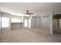 Expansive living room featuring neutral paint, carpet, and ceiling fans at 45071 W Yucca Ln, Maricopa, AZ 85139
