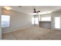 Spacious living room with neutral paint, carpet, and multiple windows for natural light at 45071 W Yucca Ln, Maricopa, AZ 85139