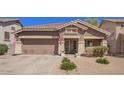 Charming single-story home featuring a well-manicured lawn, two-car garage and inviting entryway at 4552 E County Down Dr, Chandler, AZ 85249