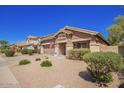 Charming single-story home featuring a well-manicured lawn, two-car garage and inviting entryway at 4552 E County Down Dr, Chandler, AZ 85249