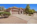 Charming single-story home featuring a well-manicured lawn, two-car garage and inviting entryway at 4552 E County Down Dr, Chandler, AZ 85249