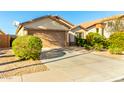 Charming single-Gathering home with a two-car garage and a well-maintained front yard at 45564 W Sheridan Rd, Maricopa, AZ 85139