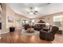 Comfortable living room featuring a ceiling fan and sliding glass doors to the patio at 45564 W Sheridan Rd, Maricopa, AZ 85139
