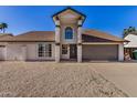 Charming home exterior with pillars, neutral color scheme, and a well-maintained front yard at 4940 E Grandview St, Mesa, AZ 85205