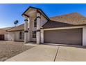 Charming home exterior with pillars, neutral color scheme, and a well-maintained front yard at 4940 E Grandview St, Mesa, AZ 85205