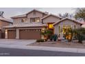 Charming two-story home featuring a three-car garage and beautifully landscaped front yard with desert plants at 5342 W Linda Ln, Chandler, AZ 85226