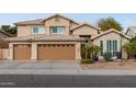 Inviting two-story home with a three-car garage and desert landscaping, offering curb appeal and charm at 5342 W Linda Ln, Chandler, AZ 85226