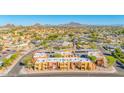 A beautiful aerial view of the apartment complex with surrounding neighborhoods and desert mountains in the background at 604 E Weber Dr # 12, Tempe, AZ 85288