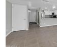 Bright living room with tile floors flowing into a kitchen area with stainless steel appliances at 604 E Weber Dr # 12, Tempe, AZ 85288