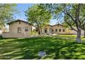 Well-maintained home exterior with a lush green lawn and mature trees at 8336 S Homestead Ln, Tempe, AZ 85284