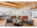 Spacious living room featuring beamed ceilings, a large sectional, and a seamless flow to the kitchen at 8336 S Homestead Ln, Tempe, AZ 85284