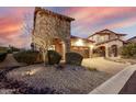 Home exterior with stone accents, desert landscaping, and driveway pavers at 8542 E Indigo St, Mesa, AZ 85207
