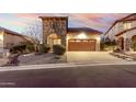Home exterior showcasing stone accents, desert landscaping, and a brick driveway at 8542 E Indigo St, Mesa, AZ 85207