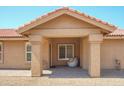 Inviting covered front porch with neutral color scheme and tiled floor at 8877 E Riviera Dr, Scottsdale, AZ 85260