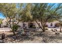 Well maintained home with mature trees and rock landscaping at 9401 N 122Nd Pl, Scottsdale, AZ 85259