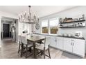 Charming dining room featuring stylish chandelier, shiplap accent wall, and open design at 10043 W Foothill Dr, Peoria, AZ 85383