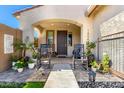 Inviting front porch with rocking chairs, potted plants and welcoming entryway at 10043 W Foothill Dr, Peoria, AZ 85383